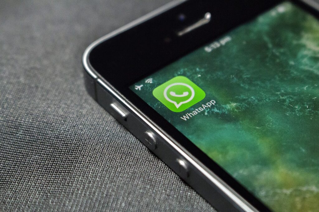 WhatsApp logo on spacegrey phone.