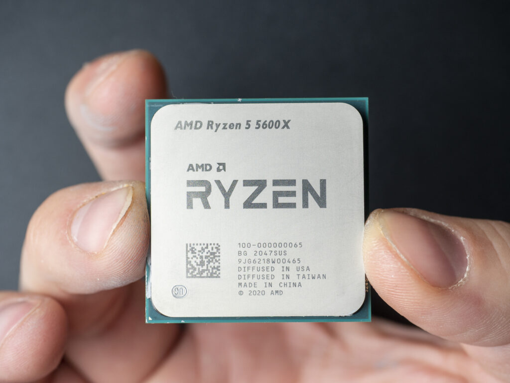 New generation Zen 3 AMD 5600X computer processor in hand close-up.