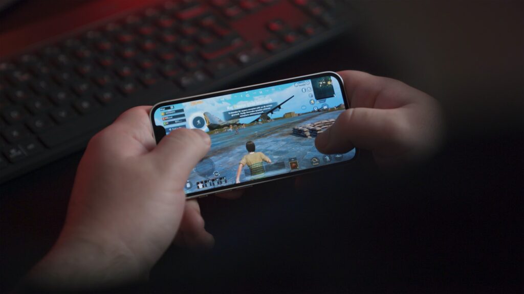 A guy is playing PUBG mobile on phone