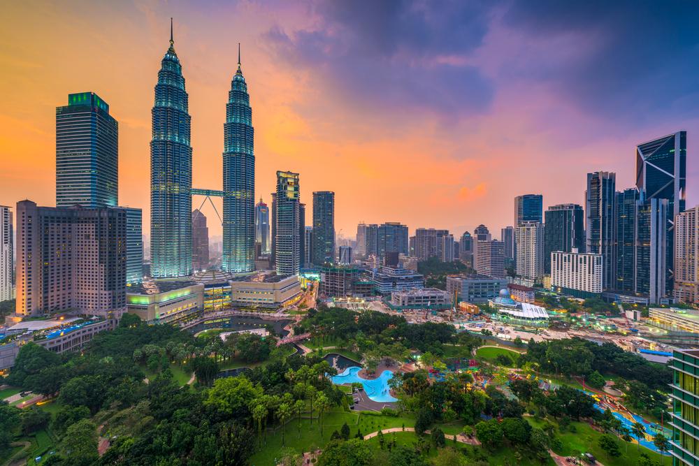Kuala Lumpur, Malaysia skyline at dusk over the park.